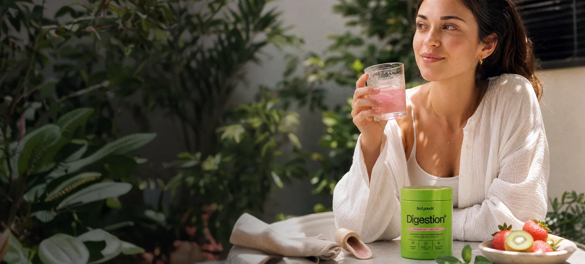 Feel Goods customer enjoying a drink outdoors with a Digestion+ tub
